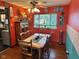 This dining room features a wooden table, ceiling fan, and a window with natural light at 5626 Hammon Dr, Brownsburg, IN 46112