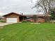Charming brick ranch-style home with an attached garage and a well-manicured lawn at 5626 Hammon Dr, Brownsburg, IN 46112