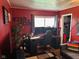 Red office space with a large window, computer setup, and gray chair at 5626 Hammon Dr, Brownsburg, IN 46112