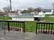Above-ground pool with white fence and decking viewed from the wood deck of the home at 5626 Hammon Dr, Brownsburg, IN 46112