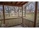 A backyard view from covered porch highlights a treehouse and chain-link fence at 5752 Echo Way, Indianapolis, IN 46278