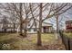 View of a home from the backyard shows a treehouse, landscaping, and fencing at 5752 Echo Way, Indianapolis, IN 46278