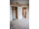 Neutral bedroom showcases plush carpeting, a closet, and leads to another room at 5752 Echo Way, Indianapolis, IN 46278