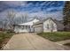 Charming home featuring white siding, a spacious front yard, and an attached two-car garage at 5752 Echo Way, Indianapolis, IN 46278