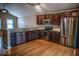 Kitchen with stainless steel appliances, granite countertops, and dark wood cabinets at 5752 Echo Way, Indianapolis, IN 46278