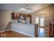 Open-concept kitchen with stainless steel appliances, granite countertops, and hardwood flooring at 5752 Echo Way, Indianapolis, IN 46278