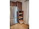 Stainless steel refrigerator and dark wood cabinets with pull out drawers at 5752 Echo Way, Indianapolis, IN 46278