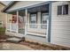 Cozy covered front porch with white railings, adding charm and curb appeal to the home's entrance at 5752 Echo Way, Indianapolis, IN 46278