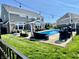 A beautiful backyard featuring a private in-ground pool with ample seating and manicured lawn for outdoor enjoyment at 5802 Bentbrook Dr, Bargersville, IN 46106