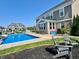 The beautiful backyard features a sparkling pool, slide, and outdoor lounge chairs for luxurious outdoor living and entertainment at 5802 Bentbrook Dr, Bargersville, IN 46106