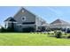 Spacious backyard with well-maintained lawn, black metal fence and patio at 5802 Bentbrook Dr, Bargersville, IN 46106