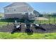 The image displays backyard patio featuring outdoor seating arranged around a mulch filled area, perfect for relaxing and socializing at 5802 Bentbrook Dr, Bargersville, IN 46106