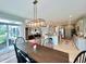 Open concept dining room with dark wood table and access to a spacious living room and kitchen at 5802 Bentbrook Dr, Bargersville, IN 46106