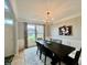 Bright dining room showcasing a long table, stylish chandelier, and view of the outdoors at 5802 Bentbrook Dr, Bargersville, IN 46106