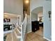 Bright foyer showcasing staircase with white railing, wood floors, and views into the dining and living rooms at 5802 Bentbrook Dr, Bargersville, IN 46106
