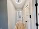 Long hallway with light hardwood floors and white trim at 5802 Bentbrook Dr, Bargersville, IN 46106