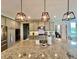 Beautiful kitchen island featuring granite countertops, modern light fixtures, and stainless steel appliances at 5802 Bentbrook Dr, Bargersville, IN 46106