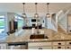 Kitchen island with granite countertops and sink, overlooking the living and dining areas at 5802 Bentbrook Dr, Bargersville, IN 46106
