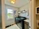 Well-lit laundry room with modern appliances, sink, and view of the yard at 5802 Bentbrook Dr, Bargersville, IN 46106