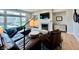 Comfortable living room with a fireplace, large windows, modern furniture, and stylish decor at 5802 Bentbrook Dr, Bargersville, IN 46106