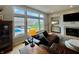Comfortable living room showcasing large windows with a view of the backyard pool and well-kept lawn at 5802 Bentbrook Dr, Bargersville, IN 46106