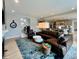 Open-concept living room with a large leather sectional, fireplace, and connection to the kitchen at 5802 Bentbrook Dr, Bargersville, IN 46106