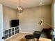 Cozy living room with hardwood floors, modern light fixture and comfortable seating at 5802 Bentbrook Dr, Bargersville, IN 46106