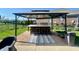 Outdoor kitchen under a gazebo, complete with bar seating, is the ideal space for cooking, dining, and entertaining guests at 5802 Bentbrook Dr, Bargersville, IN 46106