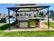 This backyard shows a complete outdoor kitchen with stainless steel appliances under a gazebo, perfect for entertaining at 5802 Bentbrook Dr, Bargersville, IN 46106