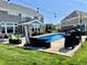 Inviting backyard pool surrounded by comfortable outdoor seating and lush greenery at 5802 Bentbrook Dr, Bargersville, IN 46106