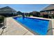 Inviting backyard pool area with slide, lounge chairs, and outdoor kitchen setup at 5802 Bentbrook Dr, Bargersville, IN 46106