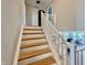 Wooden staircase leading to the second floor with views into the kitchen area at 5802 Bentbrook Dr, Bargersville, IN 46106