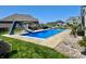 A large in-ground pool with a slide and an outdoor dining area, perfect for outdoor entertainment and summer fun at 5802 Bentbrook Dr, Bargersville, IN 46106