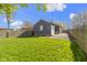 A spacious, green backyard featuring a detached garage and a well-maintained lawn with a wooden fence at 6164 Evanston Ave, Indianapolis, IN 46220