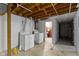 Spacious basement with washer and dryer, and open ceiling at 6164 Evanston Ave, Indianapolis, IN 46220