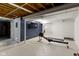 Spacious basement featuring exposed ceiling and a TV for entertainment at 6164 Evanston Ave, Indianapolis, IN 46220