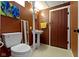 Rustic basement bathroom featuring a pedestal sink and painted walls at 6164 Evanston Ave, Indianapolis, IN 46220