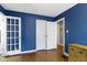 A bedroom with hardwood floors, good light, and nice double doors at 6164 Evanston Ave, Indianapolis, IN 46220