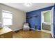 A stylish bedroom features a chair, wood floors, and good light at 6164 Evanston Ave, Indianapolis, IN 46220