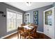 Cozy dining area with wooden table set near a bright window and charming decor at 6164 Evanston Ave, Indianapolis, IN 46220