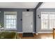 Bright entryway featuring a white door, hardwood floors, and natural light at 6164 Evanston Ave, Indianapolis, IN 46220