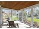 Relaxing screened front porch offering a view of the landscaped front yard at 6164 Evanston Ave, Indianapolis, IN 46220