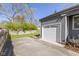 Attached one car garage and large concrete driveway with a landscaped yard at 6164 Evanston Ave, Indianapolis, IN 46220