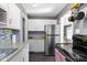 This kitchen has gray walls, white cabinets, and stainless steel appliances at 6164 Evanston Ave, Indianapolis, IN 46220