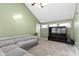 Cozy living room featuring vaulted ceilings, neutral walls, carpet, and comfortable seating area at 6164 Evanston Ave, Indianapolis, IN 46220