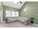 Comfortable living room with plush sectional sofa, carpet, and plenty of natural light at 6164 Evanston Ave, Indianapolis, IN 46220