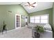 Bright living room featuring neutral walls, plush sofa, and door to another room at 6164 Evanston Ave, Indianapolis, IN 46220