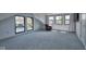 Bright bedroom with large windows, patterned carpet, and an elegant leather chair at 6173 Rosslyn Ave, Indianapolis, IN 46220