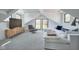 Cozy bonus room with vaulted ceilings, a large sofa, and natural light at 6173 Rosslyn Ave, Indianapolis, IN 46220