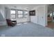 Bonus room with a leather chair, hardwood floors and view of the outdoors at 6173 Rosslyn Ave, Indianapolis, IN 46220